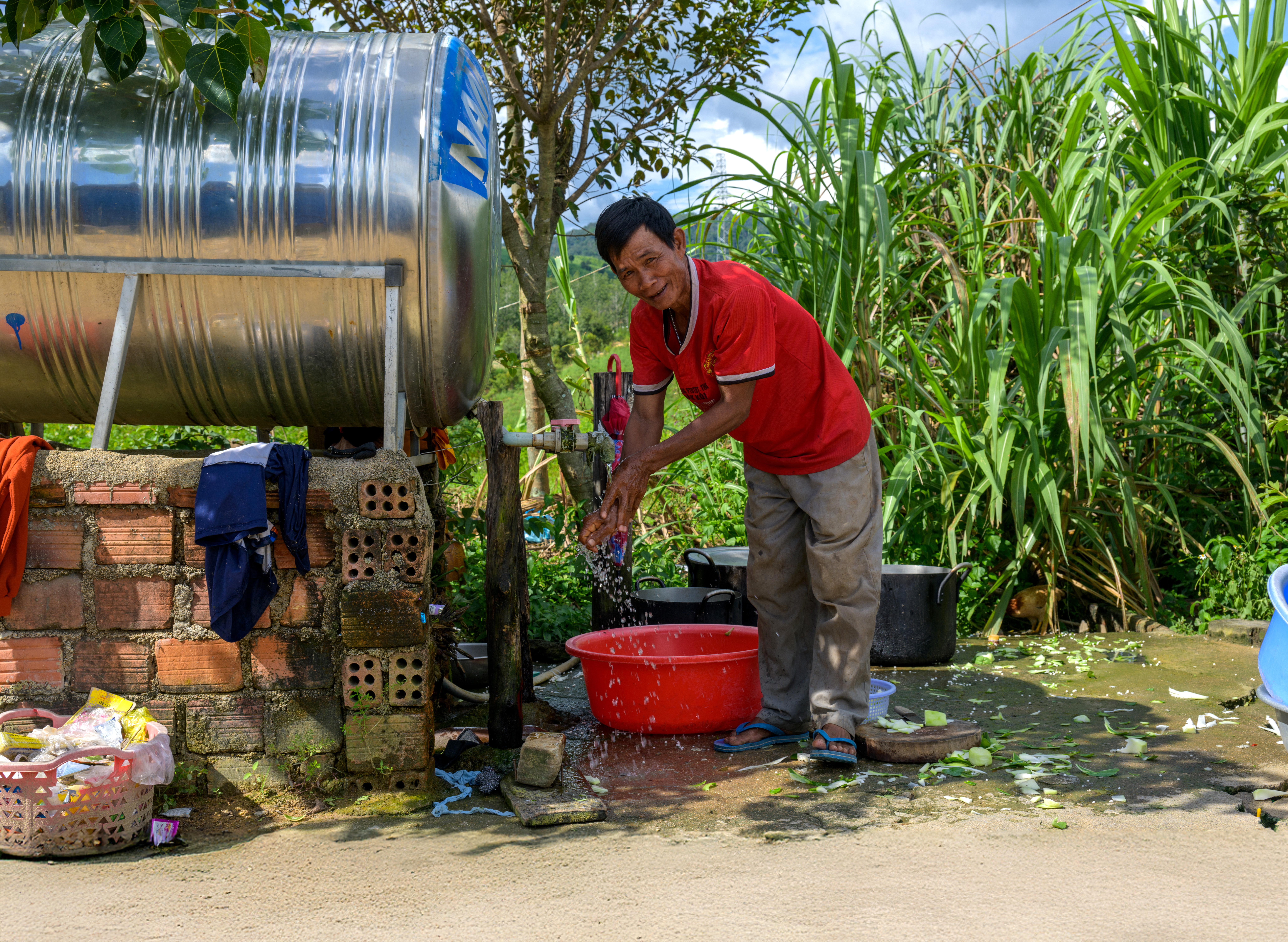 man washing hands a water tank